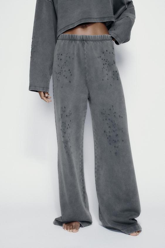 FADED-EFFECT RIPPED PLUSH TROUSERS